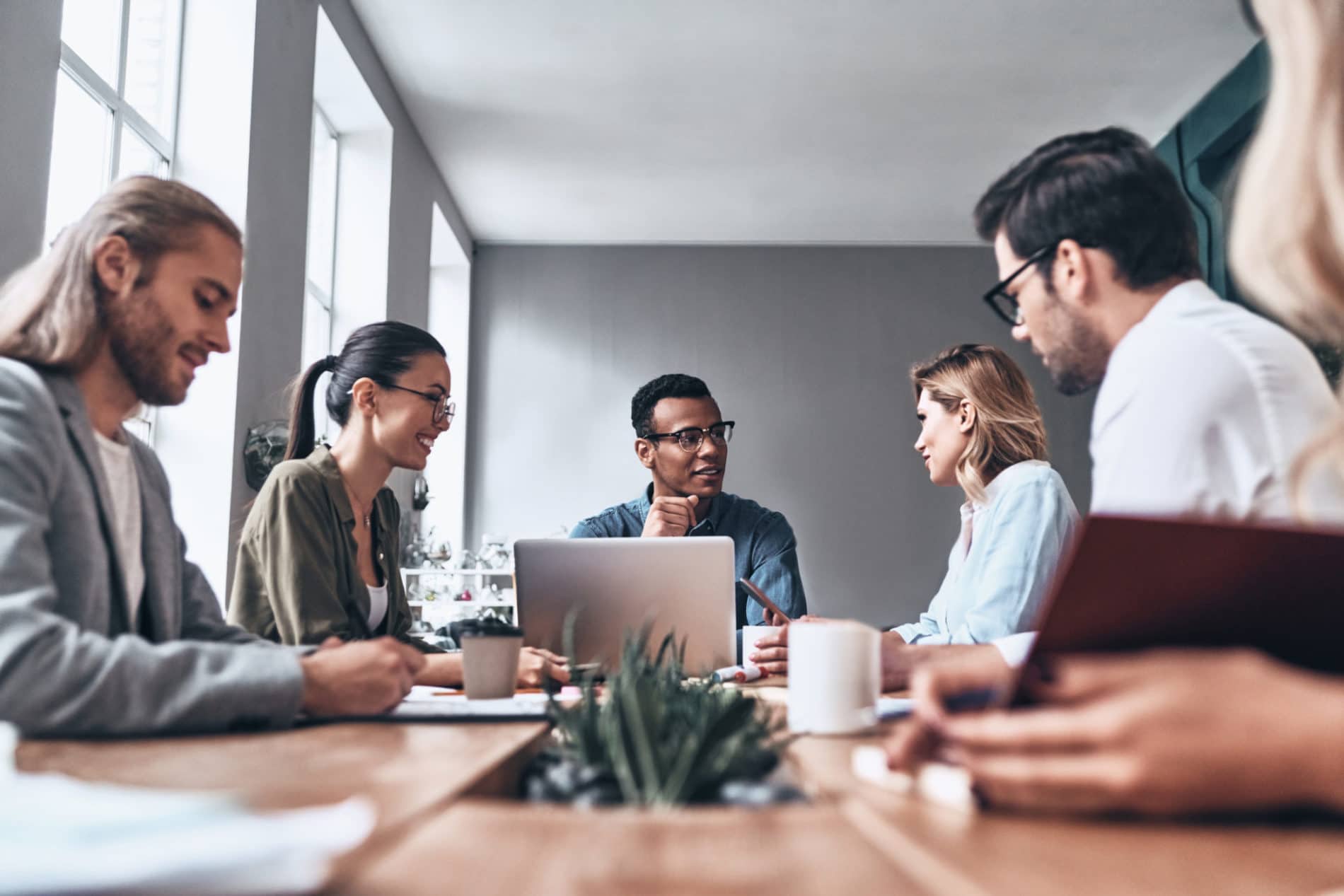 Employees have a meeting to talk about common challenges for Managed Services.