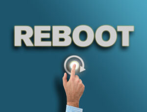 male hand pushing glowing reboot button, fresh start or new beginning concept reboot msp infiniwiz