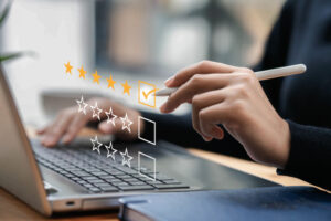 Businessman typing on a computer keyboard, customer service satisfaction survey concept. Business people choose the highest satisfaction rating and give 5 stars. Satisfaction, rating, rating. assessment test 