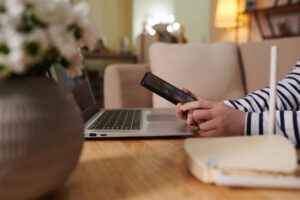 Hands of young woman installing smart home application on smartphone windows 11