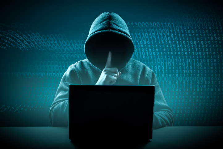 faceless hooded hacker showing silence gesture. Hacker attack. Dangerous Hooded Hacker Breaks into Government Data Servers. Cybersecurity, computer hacker with hoodie. Hacking and malware concept.