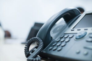 close up soft focus on telephone devices at office desk for customer service support concept
